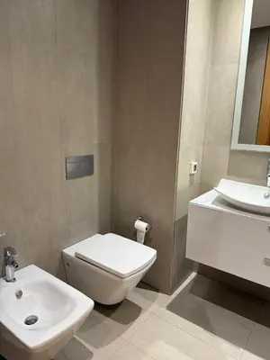 a bathroom with a white toilet and a sink at Marina de Casablanca in Casablanca