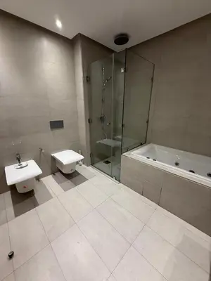 a bathroom with a shower and a sink and a tub at Marina de Casablanca in Casablanca
