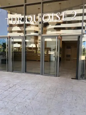a building with glass doors and a sign on it at Marina de Casablanca in Casablanca