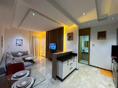 a living room with a couch and a tv at Modern Apartment in Maarif Princess in Casablanca