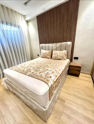 a bedroom with a large bed and a window at Modern Apartment in Maarif Princess in Casablanca