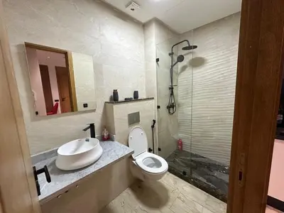 a bathroom with a toilet and a sink and a shower at Modern Apartment in Maarif Princess in Casablanca