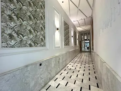 a hallway with a tile floor and a painting on the wall at Modern Apartment in Maarif Princess in Casablanca