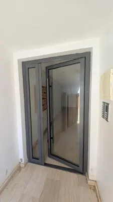 a sliding glass door in a room at Blue Haven Pool Suites in Pont Blondin