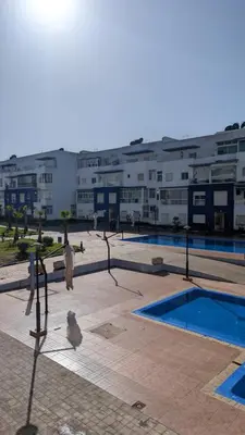 a view of a building with a pool and buildings at Blue Haven Pool Suites in Pont Blondin