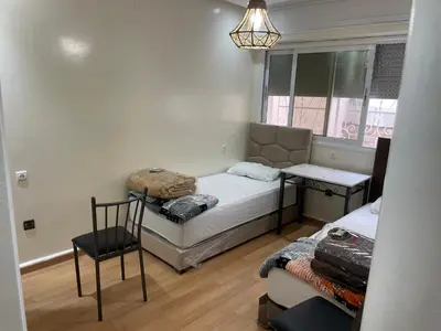 a small room with two beds and a window at Casablanca Apartments & B&Bs in Casablanca
