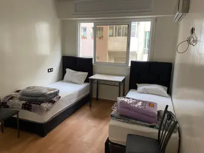 a small room with two beds and a window at Casablanca Apartments & B&Bs in Casablanca