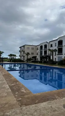 an empty swimming pool in front of a building at Magic house in Mansouria