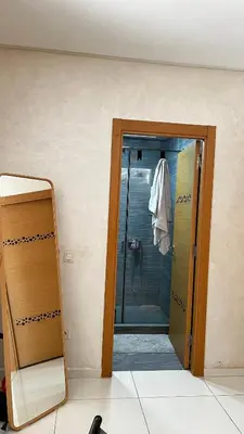 a bathroom with a walk in shower and a mirror at Magic house in Mansouria