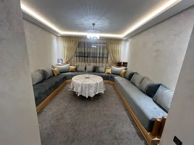a living room with a couch and a table at Dar Lakbira Bouznika in Bouznika