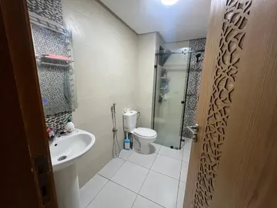 a bathroom with a shower and a toilet and a sink at Dar Lakbira Bouznika in Bouznika