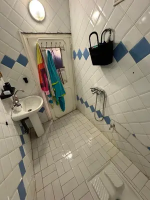 a bathroom with a sink and a shower with towels at Petit Apparemment pas chère à 3km du grand stade de rabat in Temara