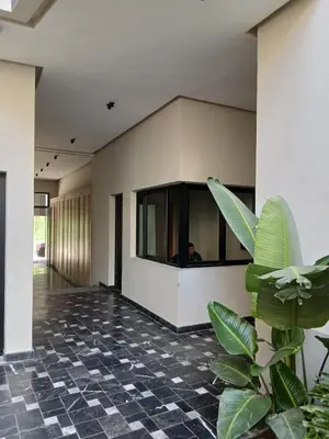 a person sitting in the window of a building at BeauLiving Park in Casablanca