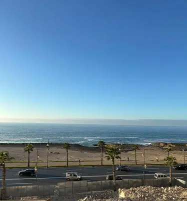 a parking lot with the ocean in the background at oceon vue rabat center in Rabat