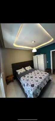 a bedroom with a large bed with a blue wall at oceon vue rabat center in Rabat