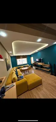 a living room with a yellow couch and a table at oceon vue rabat center in Rabat