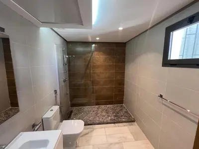 a bathroom with a shower and a toilet and a sink at Le studio Chic in Casablanca