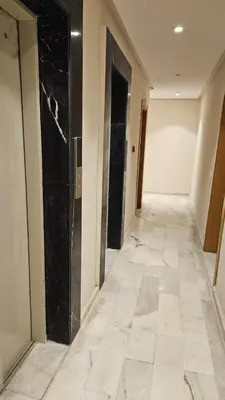 a hallway with black walls and a tile floor at Le studio Chic in Casablanca