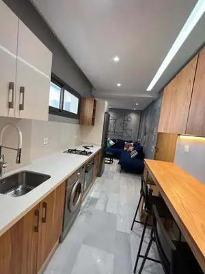 a person laying on a couch in a kitchen at Le studio Chic in Casablanca
