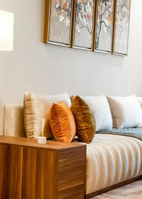 a couch with pillows on top of a wooden table at Elegance - 2 bedrooms with Pool - 5 min Airport in Nouaseur