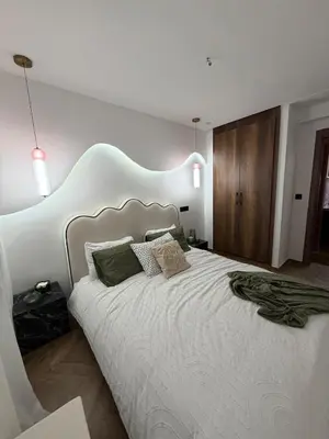 a bedroom with a large white bed with two pillows at Luxurious studio with Jacuzzi in Casablanca in Casablanca