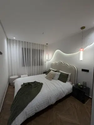 a bedroom with a large bed with a large headboard at Luxurious studio with Jacuzzi in Casablanca in Casablanca