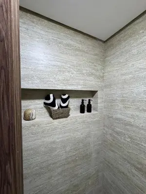 a walk in shower with two shelves with shoes at Luxurious studio with Jacuzzi in Casablanca in Casablanca