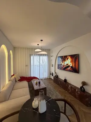 a living room with a couch and a fireplace at Luxurious studio with Jacuzzi in Casablanca in Casablanca