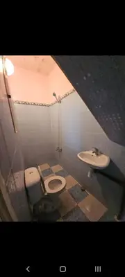 a bathroom with a toilet and a sink at Targuist in Settat