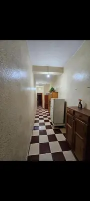 a hallway with a checkered floor in a room at Targuist in Settat
