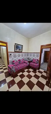 a couch in a room with a checkered floor at Targuist in Settat