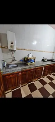 a kitchen with a sink and a tiled floor at Targuist in Settat