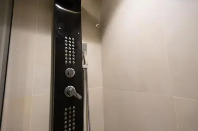 a shower stall with a black door and a shower at Luxury Studio near to hassan 2 in Casablanca
