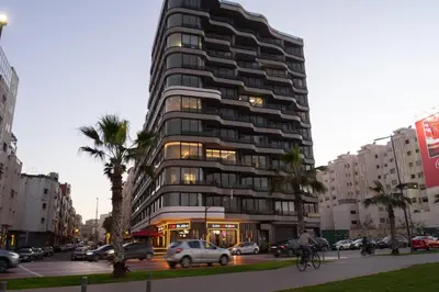 a tall building on a city street with cars at Luxury Studio near to hassan 2 in Casablanca
