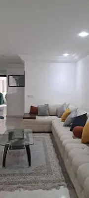 a living room with a couch and a coffee table at Appartement près de la corniche in Casablanca