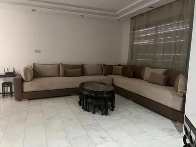 a living room with a couch and a table at Love appartement1 in Casablanca