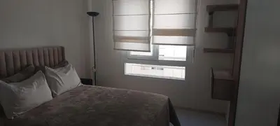 a bedroom with a bed with pillows and a window at Lina Cozy City Apartment in Casablanca