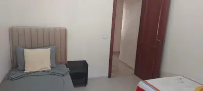 a bedroom with a bed with a pillow next to a door at Lina Cozy City Apartment in Casablanca