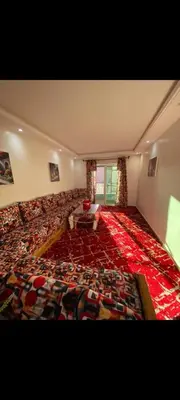 a large living room with a large red carpet at Appartement meublé à louer in Rabat