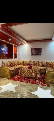 a large living room with couches and a tv at Appartement meublé à louer in Rabat