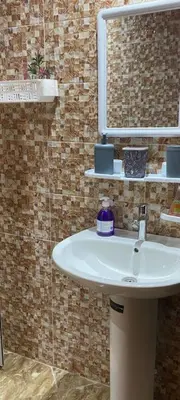 a bathroom with a sink and a mirror at Appartement meublé à louer in Rabat
