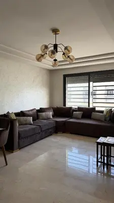 a living room with a couch and a ceiling fan at Good vibes in Casablanca