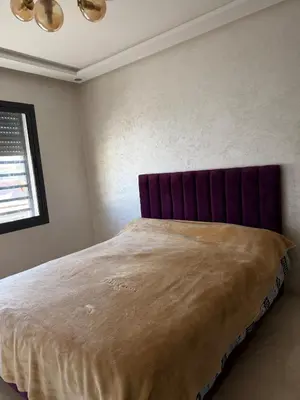 a bedroom with a large bed with a purple headboard at Good vibes in Casablanca