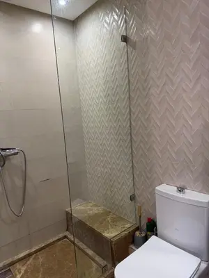 a bathroom with a toilet and a glass shower at Good vibes in Casablanca