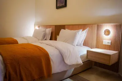 a bedroom with a large bed with white sheets and pillows at Luxury 3 Suites - Av Annakhil - 5 Min to Stadium in Rabat
