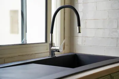 a kitchen sink with a faucet next to a window at Luxury 3 Suites - Av Annakhil - 5 Min to Stadium in Rabat