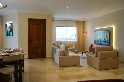 a living room with a couch and chairs and a table at Luxury 3 Suites - Av Annakhil - 5 Min to Stadium in Rabat