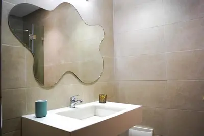 a bathroom with a sink and a mirror at Luxury 3 Suites - Av Annakhil - 5 Min to Stadium in Rabat