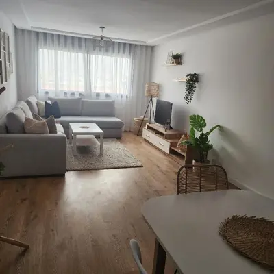 a living room with a couch and a table at Bel appart les belles rives bouznika Couples non mariés non acceptés in Bouznika