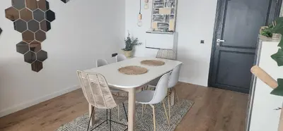 a white table and chairs in a kitchen with a refrigerator at Bel appart les belles rives bouznika Couples non mariés non acceptés in Bouznika